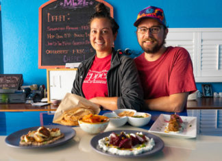 CREATIVE CUISINE – Enjoy spreads, pita bread, skewers at Meze Morada - A person sitting at a table with a plate of food - Breakfast