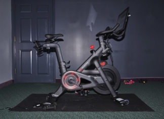 Top 10 Gifts Worse than a Peloton - A motorcycle is parked on the side of the room - Bicycle