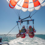 GLIDING INTO SEASON LIKE … - A parachute with a body of water - Parasailing