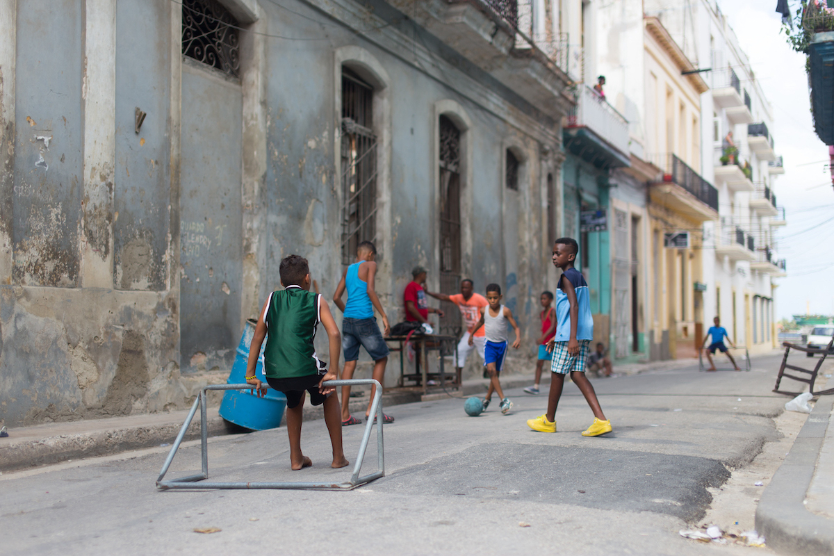 Learn about how to travel to Cuba at Marathon Library talk - A group of people walking on a sidewalk - Street