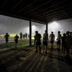 Spectators seek shelter during halftime of the Coral Shores boys varsity soccer game versus Keys Gate.