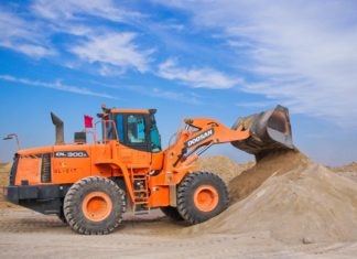 orange excavator on brown hill