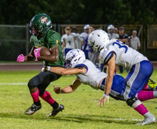 a football player is being tackled by another player