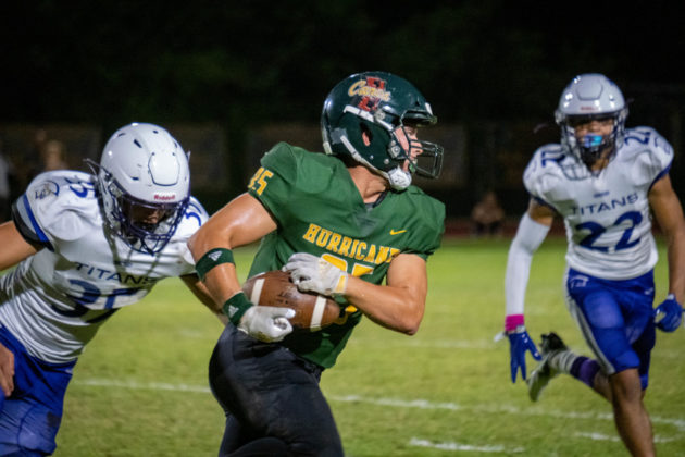 a football player running with the ball during a game