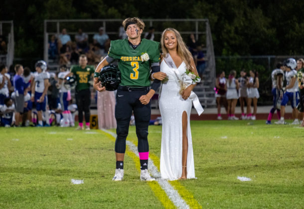 a couple of people that are standing on a field