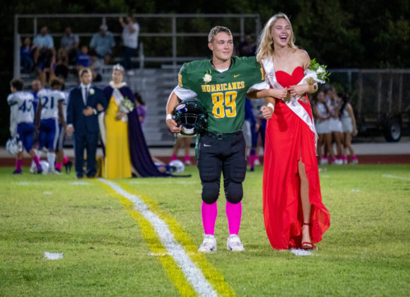 a couple of people that are standing on a field