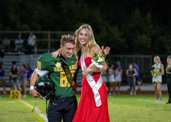 a woman in a red dress and a man in a green uniform