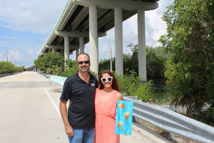 a man and a woman standing on a bridge