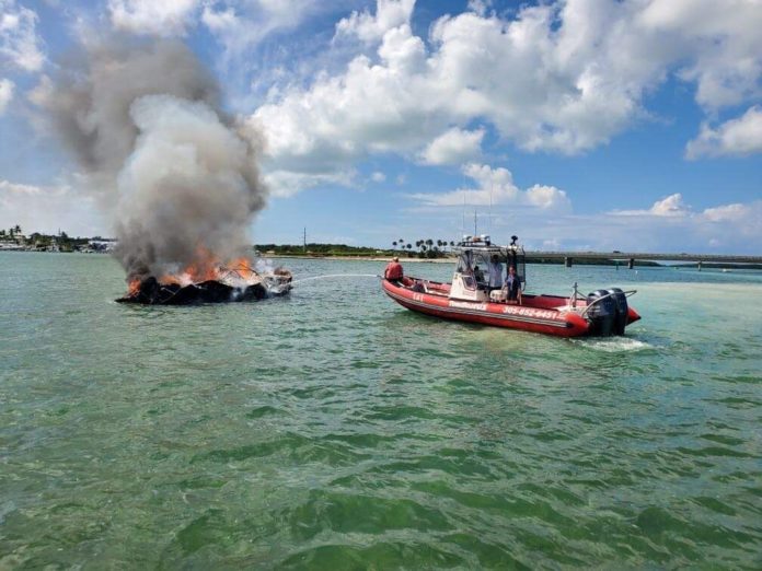 a boat on the water with a fire coming out of it