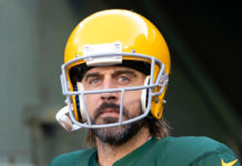 a man with a beard wearing a green and yellow football uniform