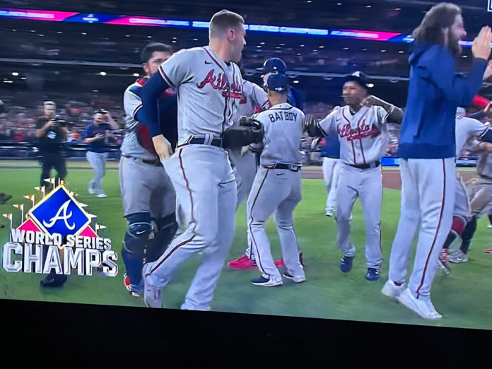 a group of baseball players standing on top of a field