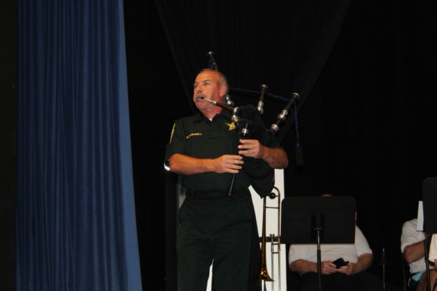 a man playing a bagpipe on a stage