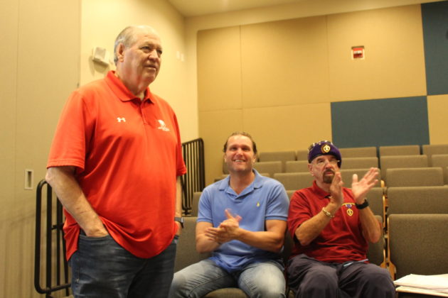 a group of men sitting next to each other in a room