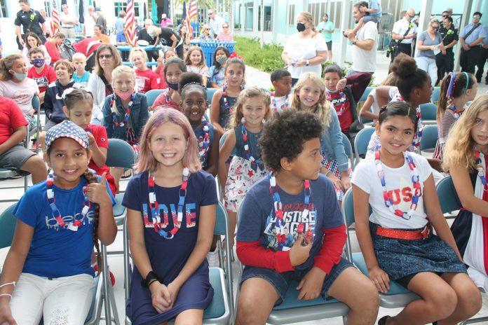 a group of young children sitting next to each other