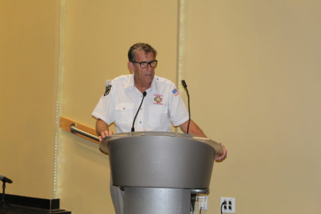 a man standing at a podium in front of a microphone