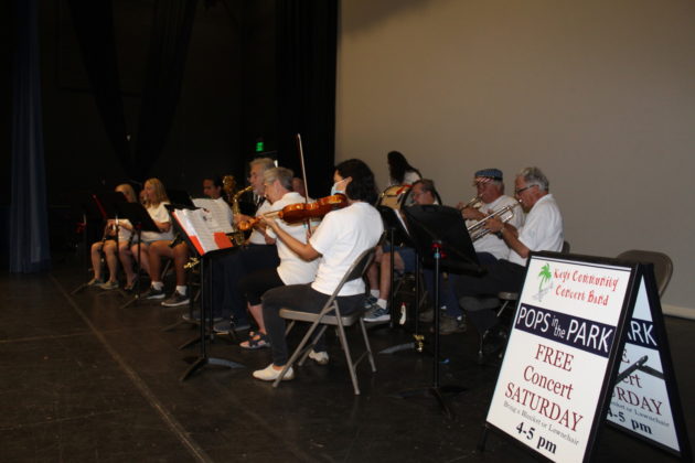 a group of people sitting in chairs playing instruments