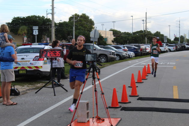a cameraman is recording a race on the street
