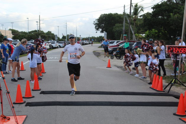 a man is running through orange cones in a race