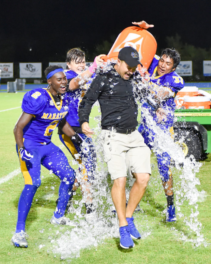a football team is sprayed with water on the field
