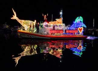 a boat decorated with christmas lights on the water