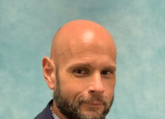 COMMISSIONER COLDIRON’S RESOLUTION PRESSURES MARTINEZ TO RESIGN a man with a bald head wearing a suit