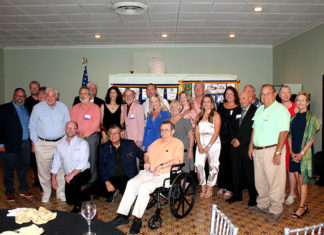 IN PICTURES: MARATHON ROTARY CLUB HOLDS 60TH ANNIVERSARY BANQUET a group of people posing for a picture in a room