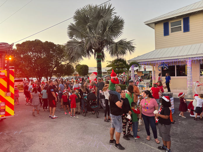 a group of people standing around a fire truck