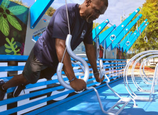 a man climbing on a blue and white playground structure