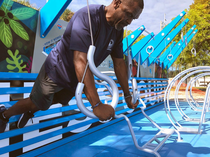 a man climbing on a blue and white playground structure