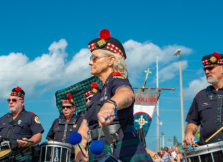 a group of men in kilts playing drums