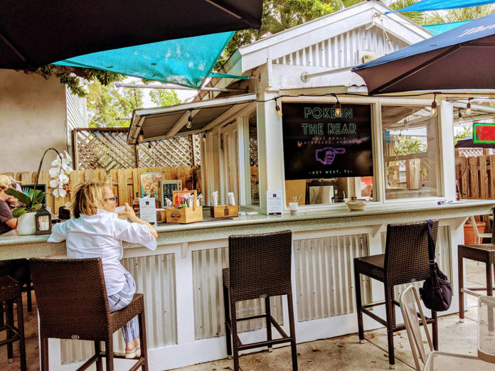 a woman sitting at a bar in a restaurant