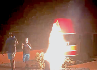 ARRESTS PENDING FOR 2 SUSPECTS IN SOUTHERNMOST POINT FIRE a couple of people standing next to a fire