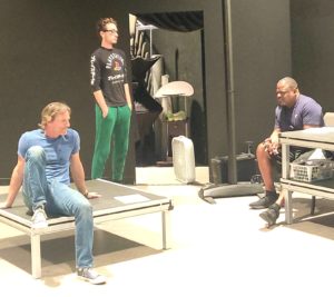 a group of men sitting on top of benches