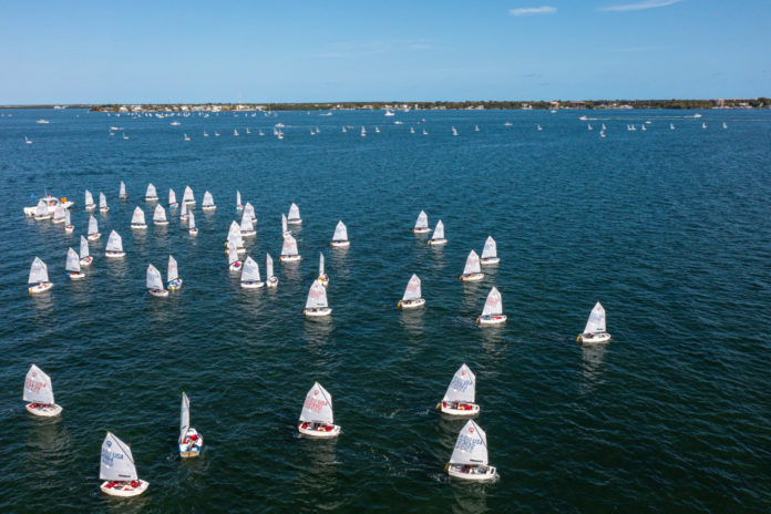 a large group of sailboats in the water