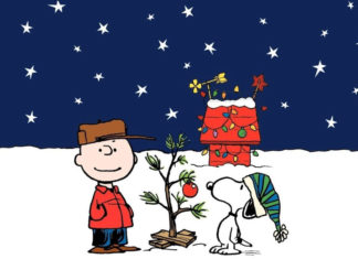 a charlie brown christmas card with a tree and a man