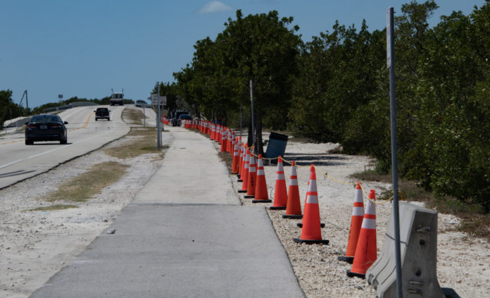 Fills parking a road with orange traffic cones on the side of it