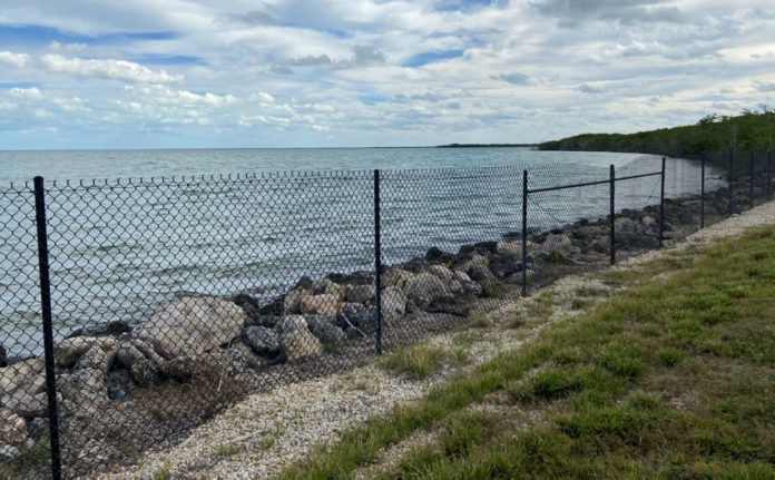 a large body of water sitting next to a fence