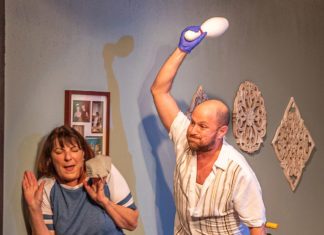 a man and a woman are playing with a frisbee