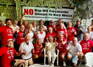 a group of people in red shirts posing for a picture