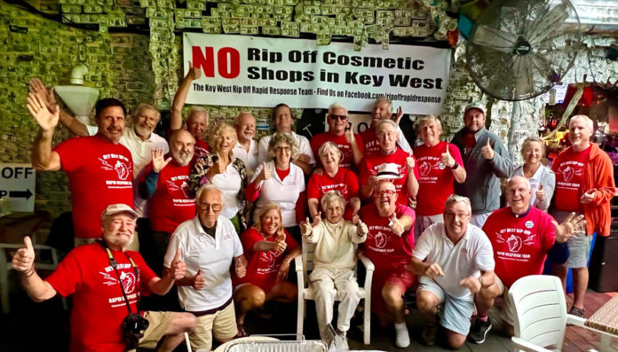a group of people in red shirts posing for a picture