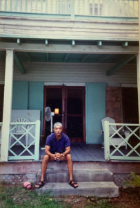 a man sitting on the steps of a house