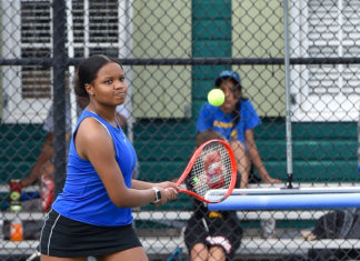 a woman holding a tennis racquet on a tennis court