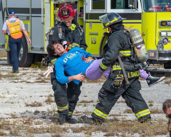 a woman is being carried away from a fire truck