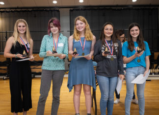 a group of young women standing next to each other