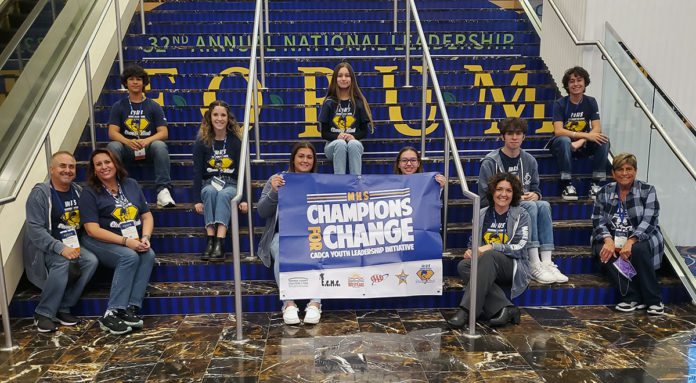 a group of people sitting on the steps of a building