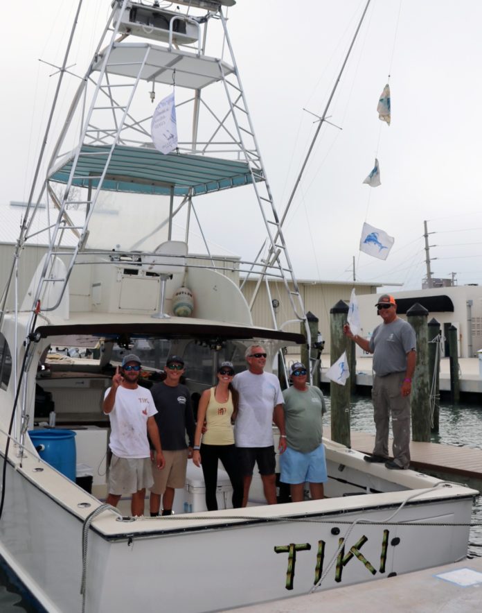 a group of people standing on a boat in the water