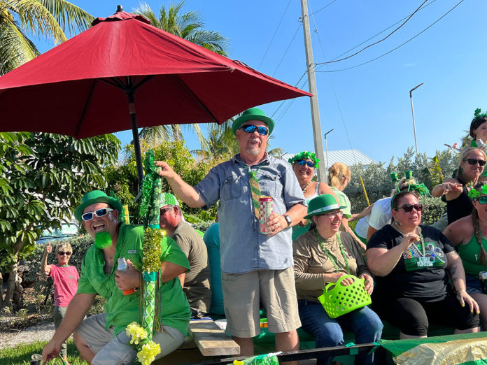 a group of people sitting under a red umbrella