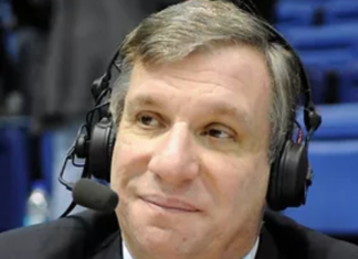 a man in a suit and tie wearing headphones