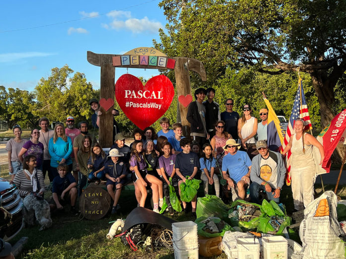 a group of people posing in front of a sign