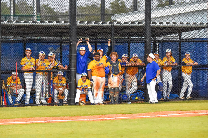 a group of baseball players standing on top of a field